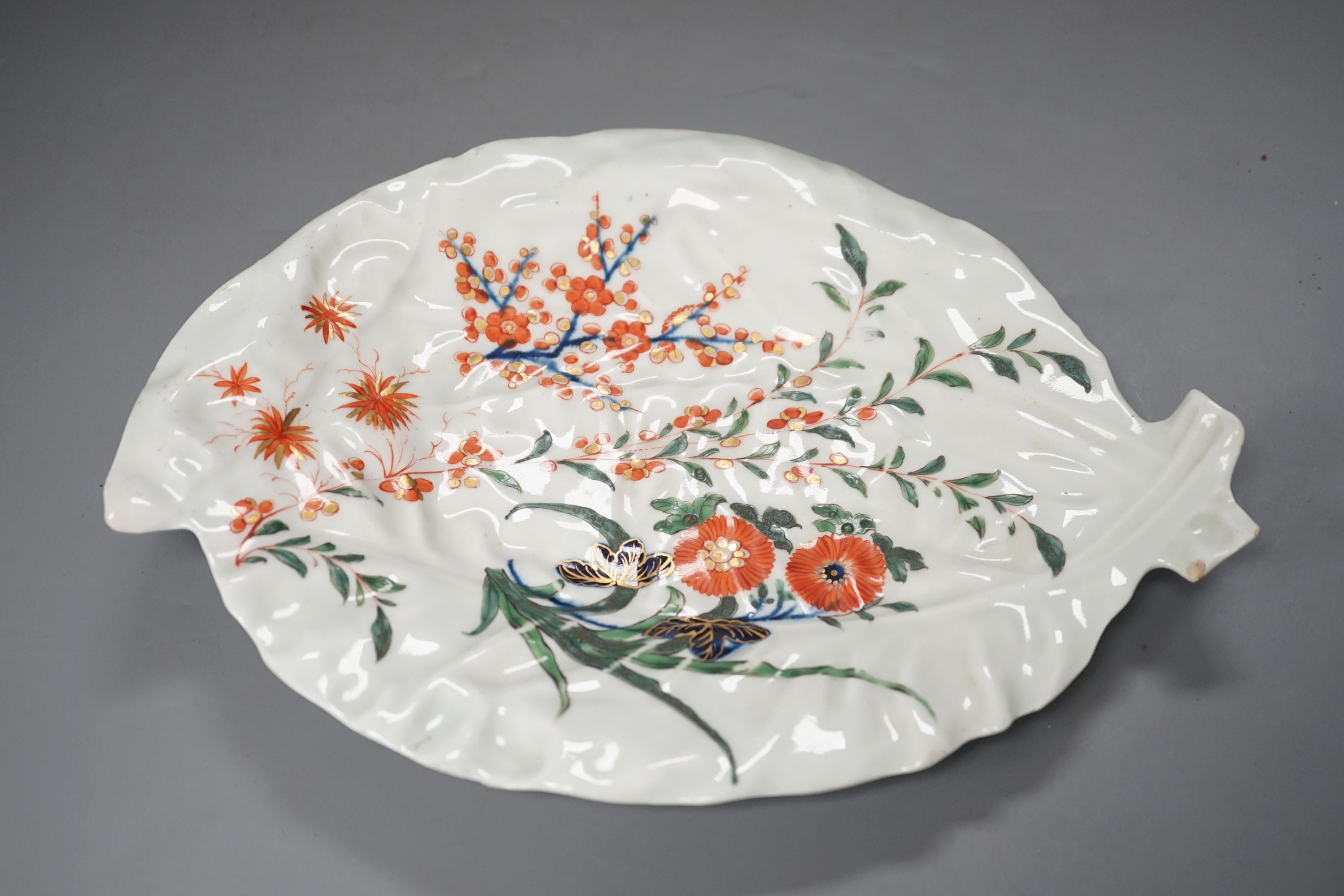 A Worcester leaf shaped dish of cos lettuce shape painted in Japanese kakiemon style with flowering plants c. 1768, 26 cms high.